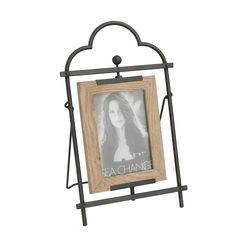 an iron and wood frame with a picture hanging on the front, holding a photo