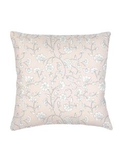 a pink pillow with white flowers on it