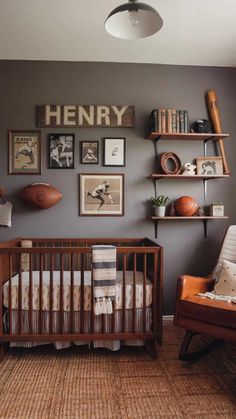 a baby's room with gray walls and pictures on the wall