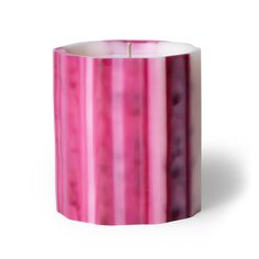 a pink and white striped candle holder on a white background with the light reflecting off of it's top