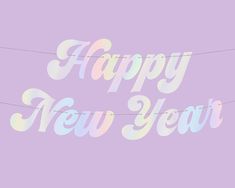 the words happy new year are painted in pastel colors on a light purple background