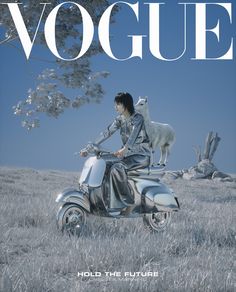 a woman riding on the back of a motorcycle next to a sheep in a field