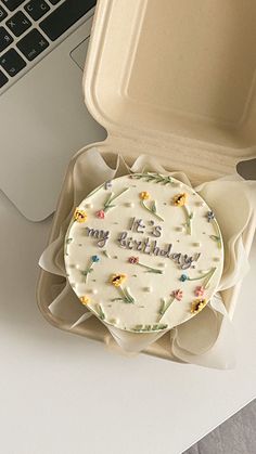 a birthday cake sitting in front of a laptop