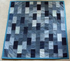 a blue and black quilt on the floor