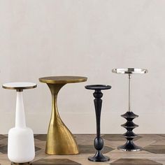 there are many different types of candles on the table and one is black, white, gold or silver