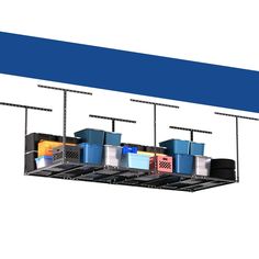 an overhead storage rack with bins and containers hanging from it's sides, in front of a white background