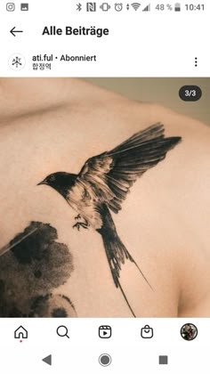 the back of a woman's shoulder with a bird on it and an arrow