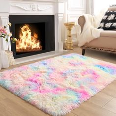 a living room with a fire place in the fireplace and rugs on the floor