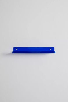 a blue piece of plastic sitting on top of a white surface