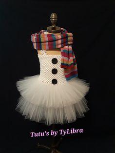 This adorable Snowgirl tutu dress is perfect for a Holiday party, Halloween costume or just for fun! This tutu dress is made with 2 layers of fluffy white tulle plus white glitter tulle mixed throughout the top shorter layer - just to add some sparkle, a white stretch crochet top embellished with black glitter buttons and thin white ruffle shoulder straps that tie around the neck.  ** SCARF IS A PHOTO PROP AND NOT INCLUDED IN THE LISTING ** When ordering select the child's clothing size or send Snowman Costume, Stretch Crochet, Crochet Tube Top, Snow Girl, Girls Costumes, White Tulle, Party Halloween, Neck Scarf, White Glitter