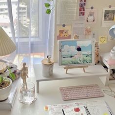 a laptop computer sitting on top of a white desk