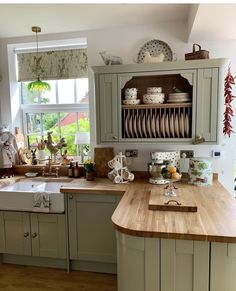 a kitchen filled with lots of counter top space and wooden counters next to a window