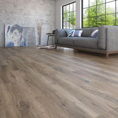 a living room with wood flooring and large windows