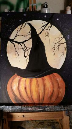 a painting of a pumpkin with a witch hat on it