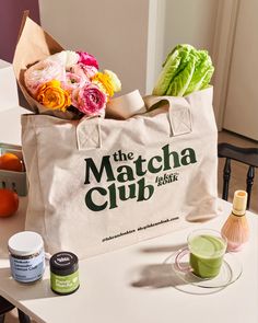 the matcha club tote bag is sitting on a table