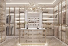 a large walk in closet with lots of gold and white items on the shelves, along with a chandelier hanging from the ceiling