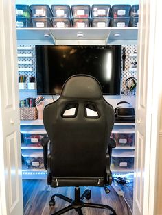 a black office chair sitting in front of a tv