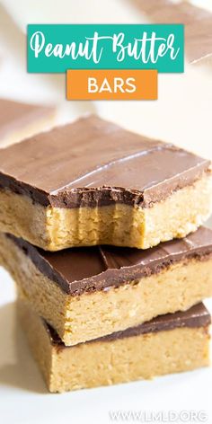 three pieces of peanut butter bars stacked on top of each other with chocolate frosting