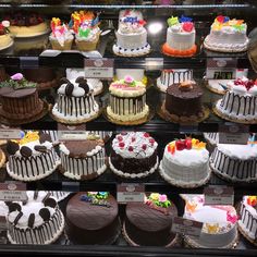 a display case filled with lots of different types of cakes on top of each other