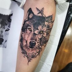 a wolf with flowers on his arm