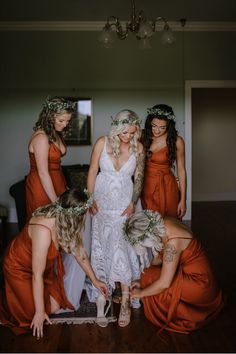 a group of women standing next to each other on top of a wooden floor in front of a mirror