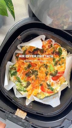 an air fryer with some food inside of it