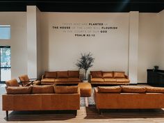 a living room filled with lots of brown furniture