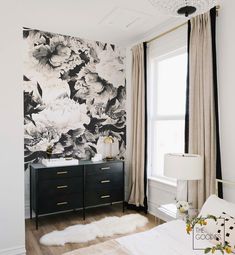 a black and white floral wallpaper in a bedroom