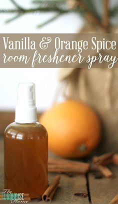 an orange spice room freshener spray is on the table next to cinnamon sticks and an orange