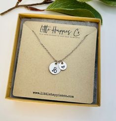 a box with a necklace in it that says little happiness co