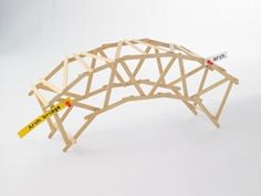 a wooden structure that is shaped like an elephant's tail and has yellow stick sticking out of it