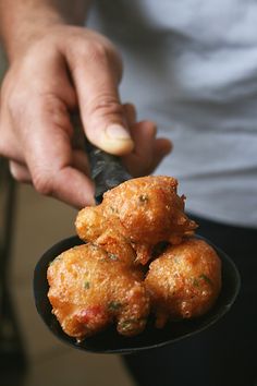 a person holding a spoon with some food in it