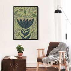 a living room with a chair and plant on the wall next to a wooden trunk