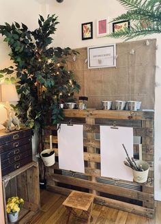 a potted plant sitting on top of a wooden table next to a white board