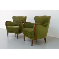 two green chairs sitting next to each other