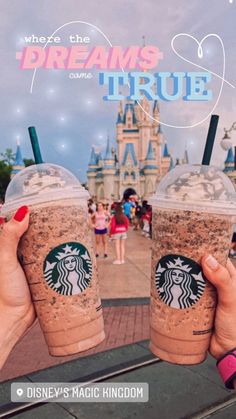 someone holding up two cups of coffee in front of a castle with the words, where the dreams are true