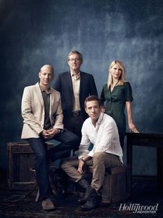 three men and two women posing for a photo in front of a blue background with the words hollywood on it