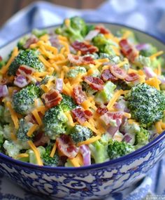 a bowl filled with broccoli and cheese on top of a table