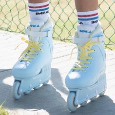 the legs and feet of a person riding roller skates