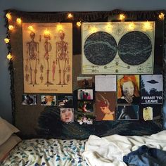 a bedroom with posters and lights on the wall