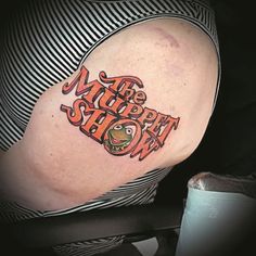 a woman with a tattoo on her arm that says the north show in an orange font