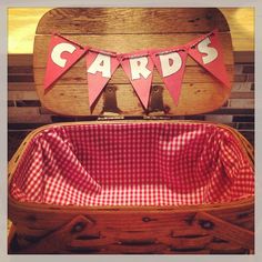 an old suitcase with a red and white gingham cloth lining the bottom that says cards