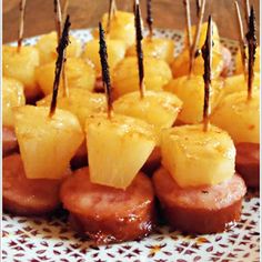 pineapples and meat on skewers with toothpicks in the middle