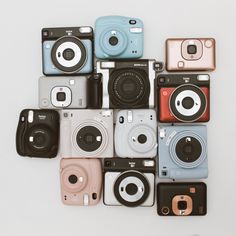 many different types of cameras sitting on top of each other