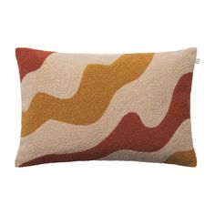 an orange and white pillow with wavy lines on the front, sitting on a white surface