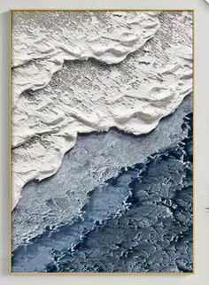 an abstract painting with blue and white waves in the water, framed on a wall