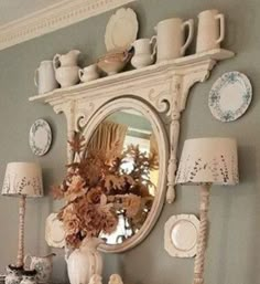 there is a mirror on the wall above a dresser with dishes and vases in it