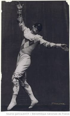 an old photo of a man doing tricks on a skateboard with his hands in the air