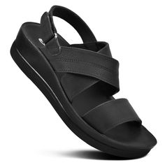 Supreme comfort and style in mind, Dione ankle strap platform sandals are the perfect addition to your warm-weather wardrobe. Featuring an open toe design and cross strap, these sandals effortlessly complement playful dresses. With a soft cushioned lining, arch support, and water-friendly gel soles, they offer a comfortable and durable option for beach vacations, errands, and everyday casual walks. The adjustable ankle strap ensures a secure fit, while the platform wedge adds a touch of elegance Black Slingback Sandals With Arch Support For Vacation, Black Strappy Sandals With Arch Support, Black Cross Strap Sandals For Vacation, Black Cross Strap Slingback Sandals For Summer, Casual Black Cross Strap Footbed Sandals, Black Cross Strap Beach Sandals, Black Closed Toe T-strap Platform Sandals, Platform T-strap Sandals With Ankle Strap For Beach, Black T-strap Sandals With Rubber Sole For Summer