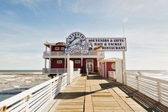 there is a sign on the pier that says something & gifts bath and taque restaurant